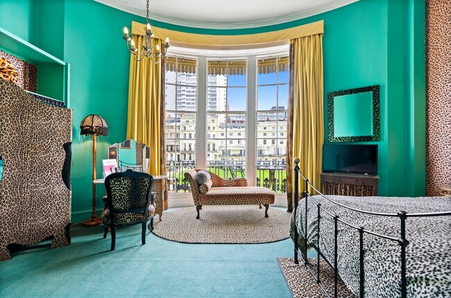 An image of a bright spacious room with leopard print curtains and rug at Hotel Pelirocco